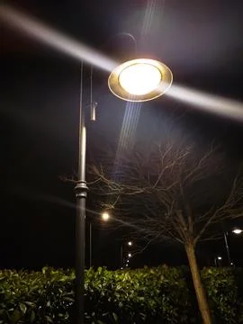 Close-up of an street lamp with split-beam shines into the camera, bottom vie Stock Photos