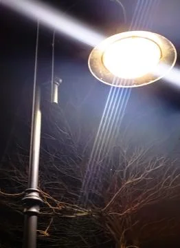 Close-up of an street lamp with split-beam shines into the camera, bottom vie Stock Photos