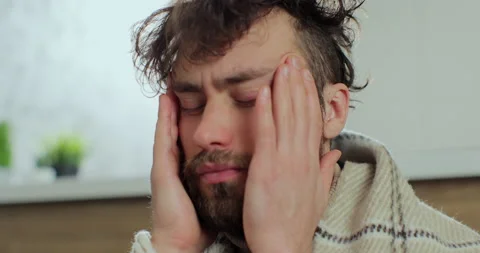Close up stressed frustrated man suffering from headache at home. Exhausted Stock Footage 168476316