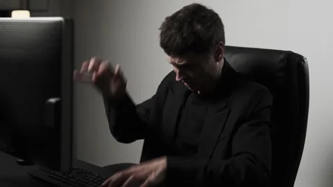 Close up of stressed man aggressively hitting computer keyboard in office anger Stock Footage 317944603