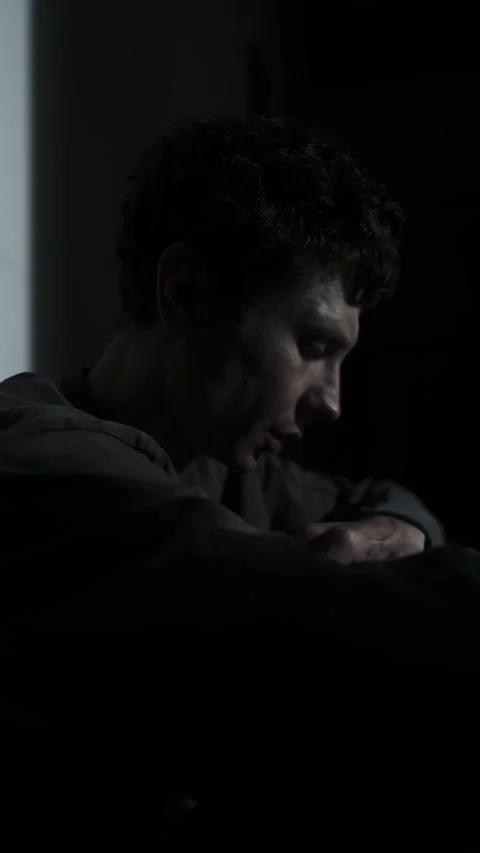 Close-up stressed man whispering to himself in the dark, inner voices and Stock Footage 324819426