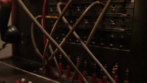 Close up of stressed out hands switching tangled telephone switchboard cables Stock Footage 131339291