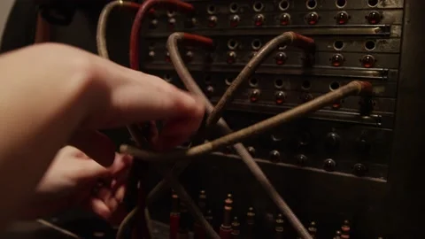 Close up of stressed out hands switching tangled telephone switchboard cables Stock Footage 131339343