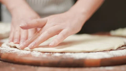 Close-up of stretching a pizza dough in slow-motion in 4K. Stock Footage 137429982