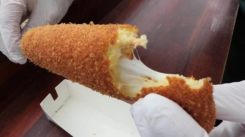 Close-up of Stretchy Mozzarella Cheese in a Crispy Korean Corn Dog, Popular Stre Stock Footage 331955858