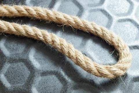 Close-up of a string of twine on a black background, symbolizing connection a Stock Photos