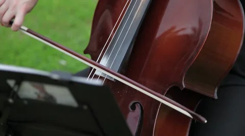 Close up on the strings of a cello vibrating Stock Footage 54923387