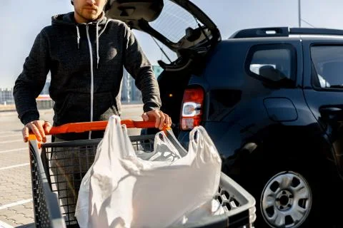 Close-up of a stroller with food near a large supermarket in a suburban shopping Stock Photos