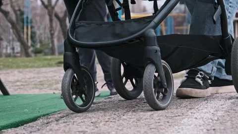 Close-Up of Stroller Wheels on Pavement Stock Footage 305408238