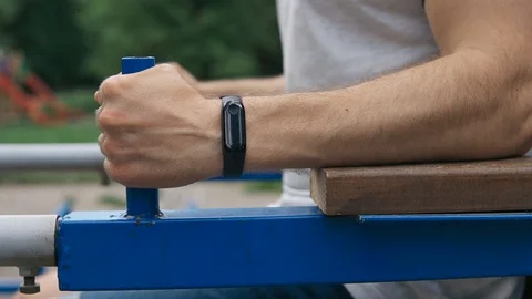 Close up of strong athlete doing press training outdoors in playground Stock Footage 129810018