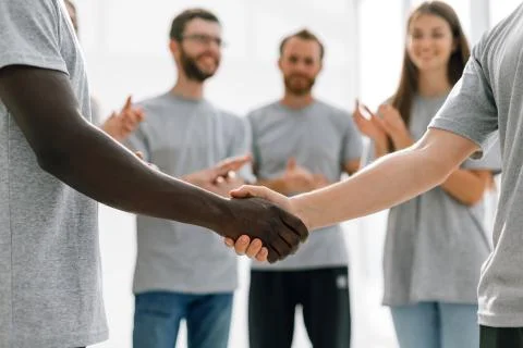 Close up. strong handshake of two students of different nationalities Stock Photos