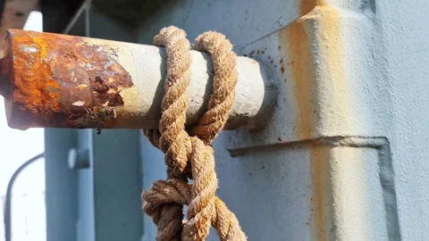 Close up of Strong Nautical Knot Tied on Rusty Industrial Metal Pipe Video stock 332448868