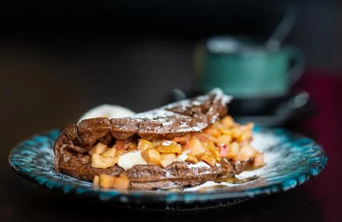 Close-up of a strudel with waffles on a table in a cafe. Stock Photos