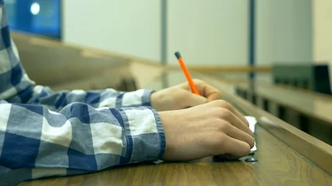 Close up student in casual sitting alone in large university lecture hall wit Stock Footage 92733189