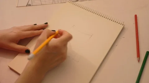 Close up student draws a pencil on paper. Female fashion designer drawing Stock Footage 113277963