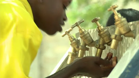 CLOSE UP: STUDENT DRINKS WATER FROM HANDS AT FAUCETS Stock Footage 59865172