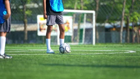 Close-up of student foot controlling soccer ball on grass field Stock Footage 339378731