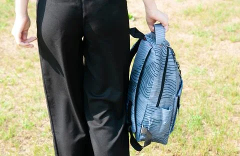 Close-up student going on grass with her backpack Stock Photos
