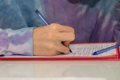 Close-up of student hand writing in notepad Foto stock