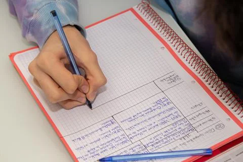 Close-up of student hand writing in notepad Stock-Fotos
