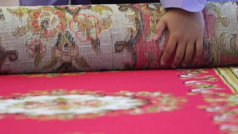 Close up of student hands rolling a large red carpet Stock Footage 336719738