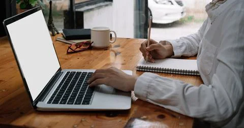 Close up of Student learning online class by using laptop computer and writing Stock Photos