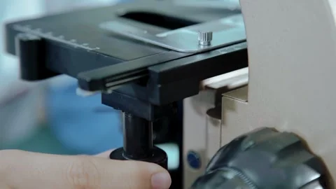 Close-up of student operating microscope Stock Footage 270395590