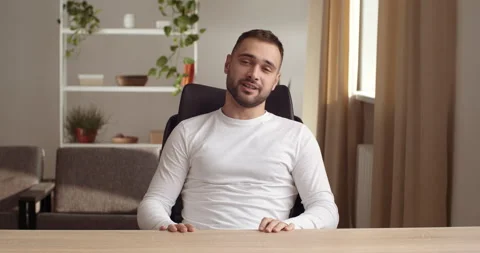 Close up student or man freelancer sits in living room speaks, passes interview Video stock 147321360