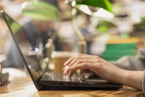 Close up of student typing on laptop for note taking at library desk Stock Photos