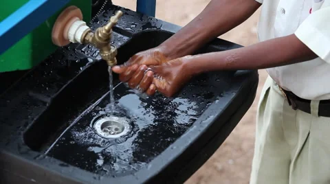 CLOSE UP: STUDENT WASHING HIS HANDS AT HANDWASHING STATION Stock Footage 60514096