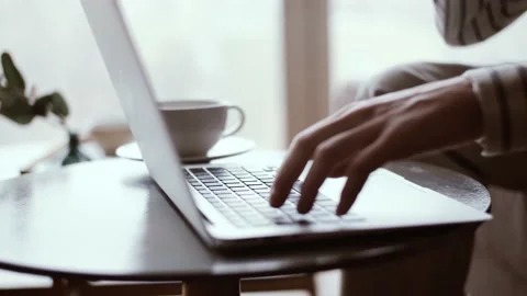 Close-up of a student working on a laptop while typing on the keyboard. Online Stock Footage 151393477