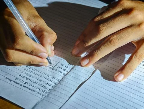 Close Up of Student Writing Math Homework with Pen on Notebook Paper Stock Photos