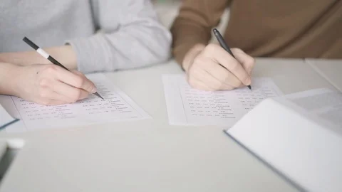 Close up of students filling in a blank with multiple choice quiz 스톡 동영상 104552298