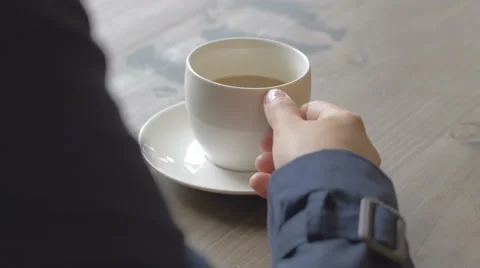 Close-up of student's hand taking a coffee cup from a table Stock Footage 67060504