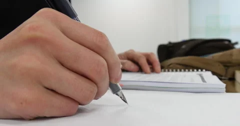 Close up of students hands with books or textbooks writing to notebooks Stock Footage 162629106