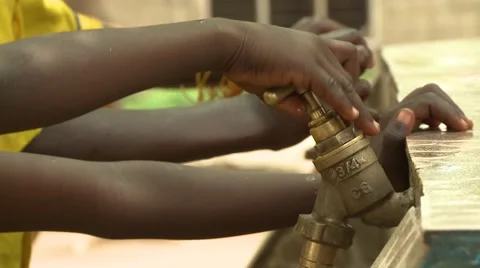 CLOSE UP: STUDENTS' HANDS TURN FAUCETS Stock Footage 60116151