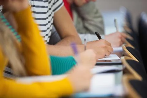 Close up of students taking notes Stock Photos
