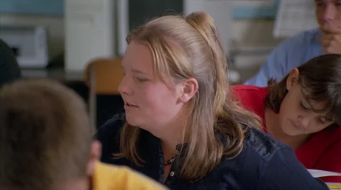 Close-up of students taking a test and of a test booklet on a student's desk Stock Footage 59533535