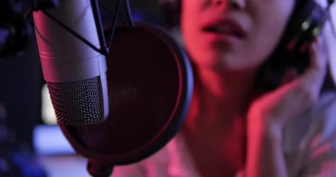 Close up of studio condenser microphone with female singing a song Видео 156438200