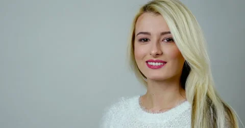 Close-up studio footage of an attractive blonde girl laughs Stock Footage 61160802