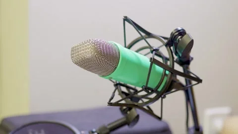 Close-up of studio microphone with a green cover in audio recording setup Stock Footage 322029994