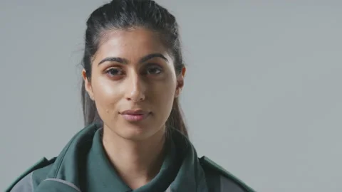 Close Up Studio Portrait Of Serious Young Female Paramedic Against Plain Stock Footage 152437723