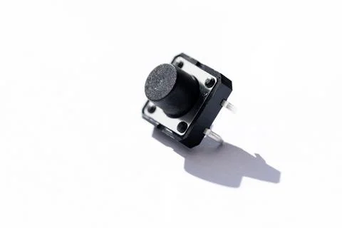 A close up studio portrait of a small push button. The electric component is  Stock Photos