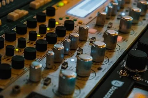Close-up of studio rack with silver knobs and illuminated indicators Stock Photos