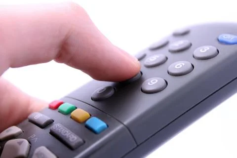 Close up studio shot of hand pressing remote control button isolated on white Stock Photos
