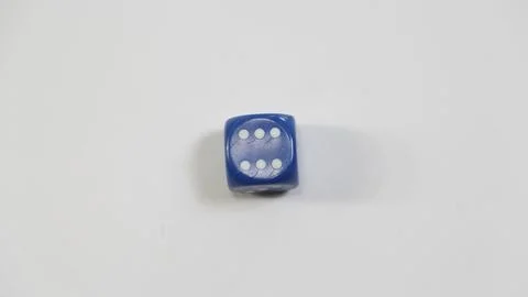 A close-up studio shot of a single blue six-sided dice with the number six fa Stock-Fotos