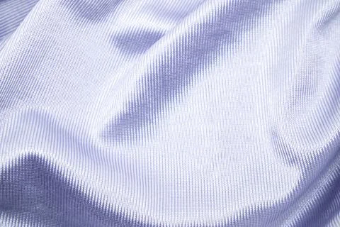 A close-up studio shot of a softly undulating light purple ribbed fabric wi.. Stock-Fotos