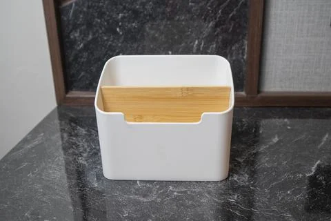 A close-up studio shot of a white plastic desktop organizer with a wooden d.. Stock Photos