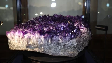 Close-up of a stunning amethyst geode displayed in a museum. The deep purple cry Stock Footage 289635862