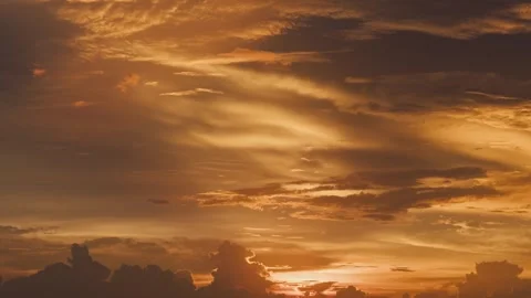 Close up of Stunning Orange Sunset Sky with Soft Clouds and Magical Golden Light Stock Footage 336038793